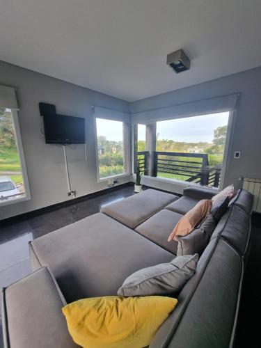 a woman laying on a couch in a living room at Casa sierra de los padres in Sierra de los Padres