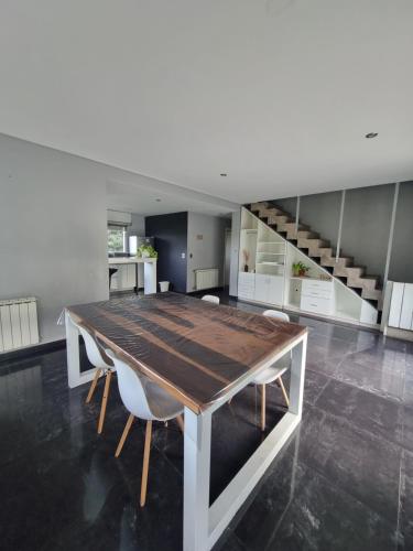 a dining room with a wooden table and chairs at Casa sierra de los padres in Sierra de los Padres