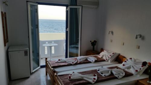 a bedroom with a bed with a view of the ocean at Tarra in Agia Roumeli