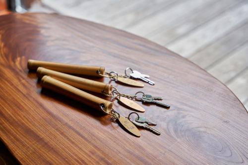 a group of pairs of scissors on a wooden table at Shima-Onsen Toshimaya in Nakanojo