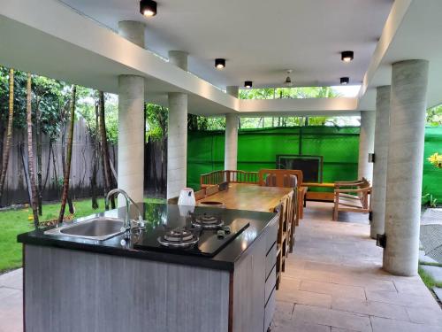 an outdoor kitchen with a sink and a patio at Fu Wan Cafe Villa in Donggang