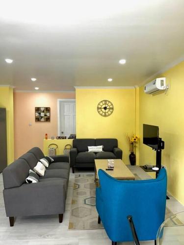 a living room with a couch and a table at Hidden Zen 108 with rental vehicle access in Castries