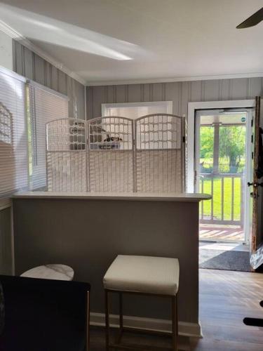 a room with a counter with a stool and a chair at Chickasaw Landing in Chickasaw