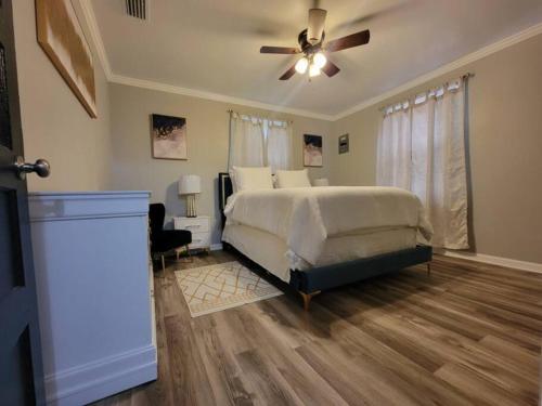 a bedroom with a bed and a ceiling fan at Chickasaw Landing in Chickasaw