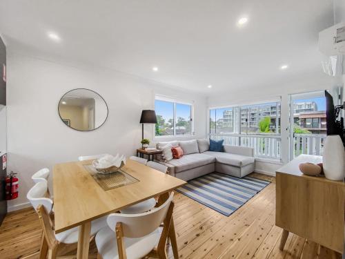 a living room with a couch and a table at Shoal Bay Beach House Three in Shoal Bay