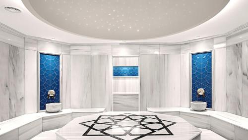 a white room with a table and some windows at Fraser Place Anthill Istanbul in Istanbul