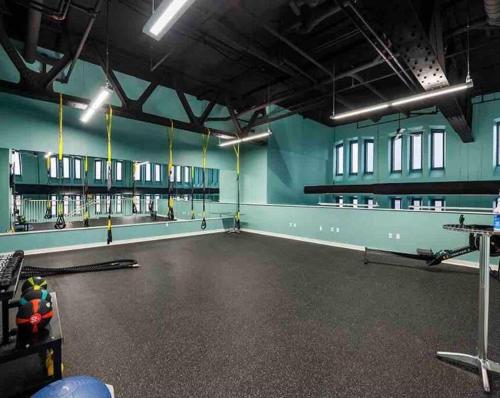 an empty room with a gym with hockey sticks at Beautiful Condo/Rooftop Patio With Free Parking in Cleveland