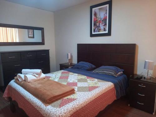 a bedroom with a bed with a quilt on it at C.A.A apartment temporal pardo 1 in Lima
