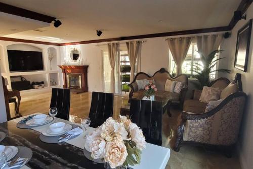 a living room with a table with flowers on it at Luxstay in Huntington Beach in Huntington Beach