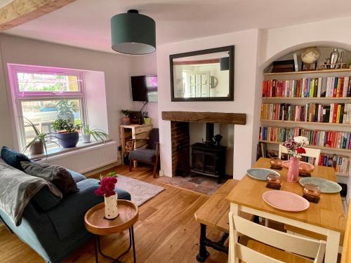 a living room with a couch and a table at Quiet & Cosy 2-Bedroom Cottage in Coltishall in Coltishall