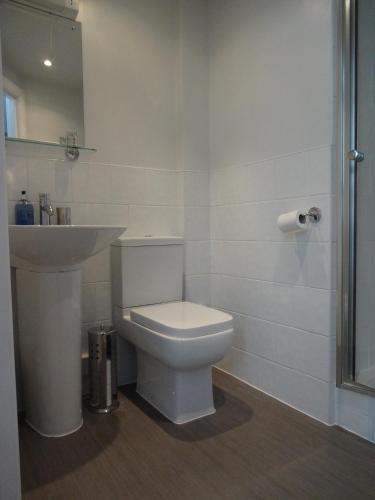 a bathroom with a white toilet and a sink at Aquarium Guest House in Brighton & Hove