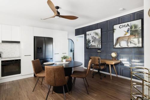 a kitchen and dining room with a table and chairs at Little Beach Boutique Apartment B Pet Friendly in Nelson Bay