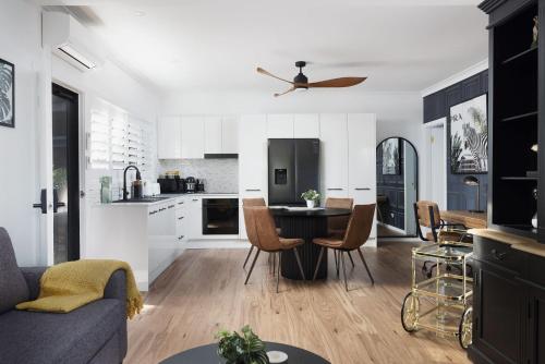 a kitchen and living room with a table and chairs at Little Beach Boutique Apartment B Pet Friendly in Nelson Bay