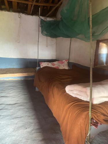 a bedroom with a bed in a tent at KB'S ECO MOUNTAIN VILLAGE HOME in Kāskī