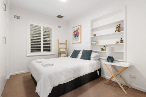 a white bedroom with a large bed and a window at 105 Sale St STAY STYLISH IN THE HEART OF ORANGE in Orange