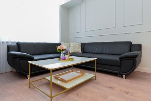 a living room with a couch and a coffee table at Nida family apartments in Nida