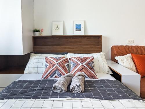 a bed with two blankets and pillows on it at Studio Condo Manila by the Bay Roxas Blvd near US Embassy in Manila