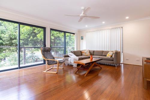 a living room with a couch and a table at Barrels at Boomerang in Boomerang Beach