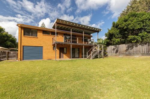 a house with a garage in a yard at Barrels at Boomerang in Boomerang Beach