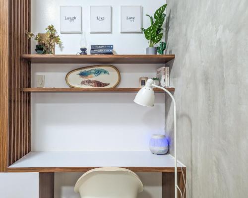 a shelf above a toilet in a room with a lamp at Studio Condo Manila by the Bay Roxas Blvd near US Embassy in Manila