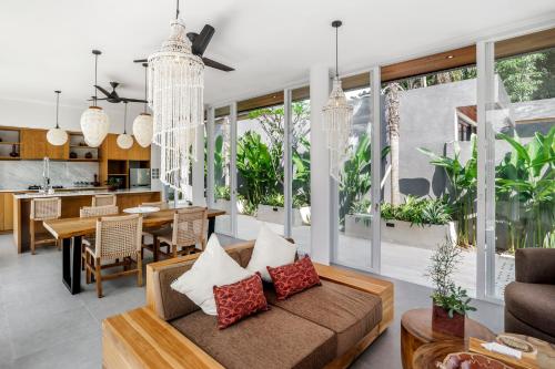 a living room with a couch and a table at Villa Paso by BaliSuperHost in Ubud