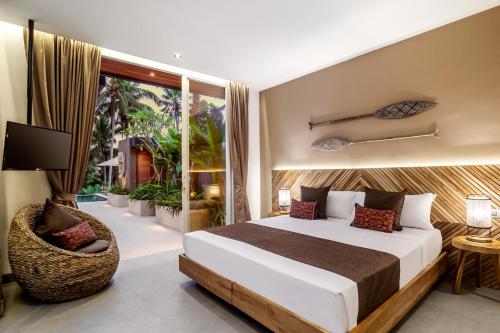 a bedroom with a large bed and a balcony at Villa Paso by BaliSuperHost in Ubud