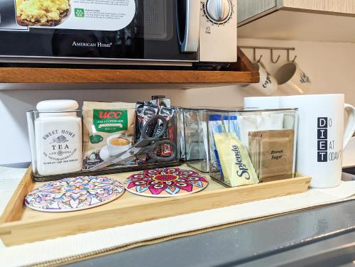a counter with plates of food and a microwave at Studio Condo Manila by the Bay Roxas Blvd near US Embassy in Manila