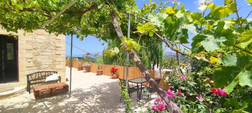 a patio with a bunch of plants and flowers at Vasiliki's Residence Amazing View in Kissamos