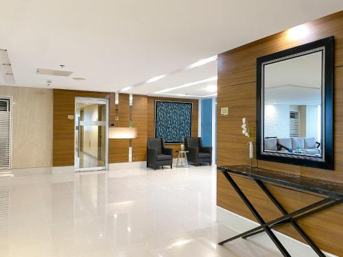 a lobby with a mirror and a waiting room at Studio Condo Manila by the Bay Roxas Blvd near US Embassy in Manila