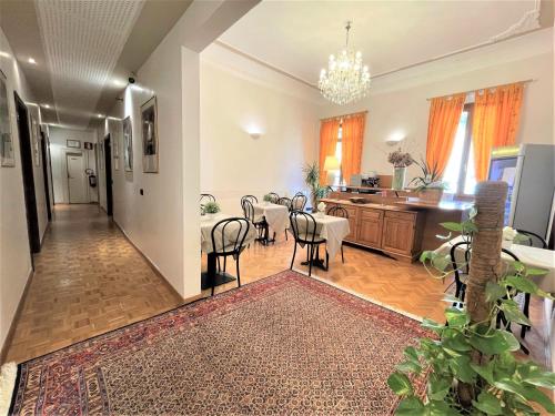 a living room with a table and chairs and a kitchen at Hotel Leopolda in Florence