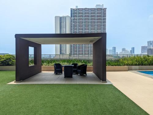 a gazebo with chairs and a view of a city at Studio Condo Manila by the Bay Roxas Blvd near US Embassy in Manila
