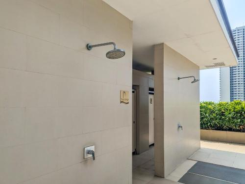 a walk in shower in a building with a window at Studio Condo Manila by the Bay Roxas Blvd near US Embassy in Manila