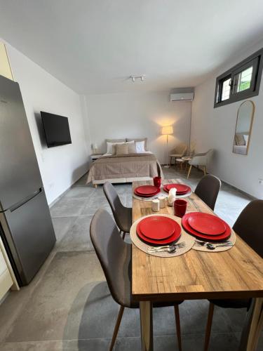 a dining room with a table and chairs and a bed at Modern & Cozy Studio in Koroni