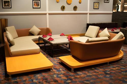 two couches and a coffee table in a living room at Ramada Plaza by Wyndham Jammu Vijaypur in Jammu