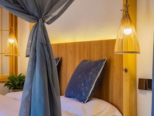 a bedroom with a bed with a blue canopy at Joke Inn in Xi'an