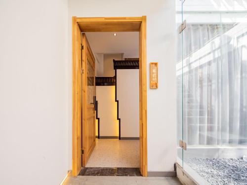 an open door to a room with a window at Joke Inn in Xi'an