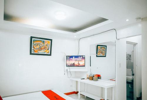 um quarto branco com uma mesa branca e um espelho em RedDoorz S&L Apartelle Daraga Albay em Legazpi