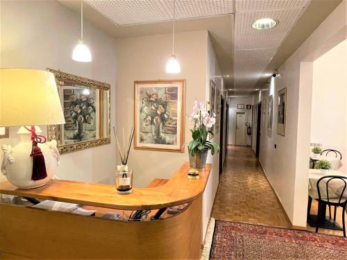 a living room with a table and a hallway at Hotel Leopolda in Florence