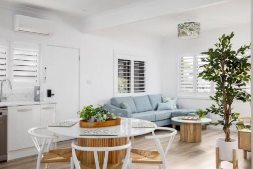 a living room with a table and a couch at Little Beach Boutique Apartment A- Pet Friendly in Nelson Bay