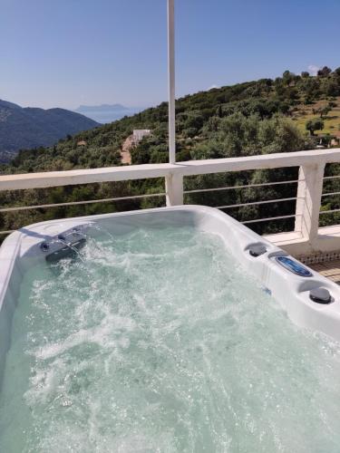 a jacuzzi tub on a balcony with a view at STATHIS GUESTHOUSE in Lefkada Town