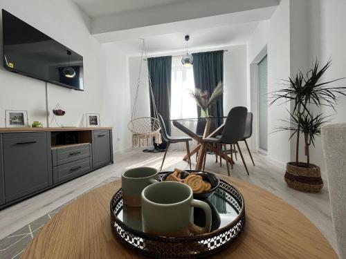 uma sala de estar com uma mesa com uma bandeja de comida em Dio's Apartment 29F-1 em Sfîntu Ilie