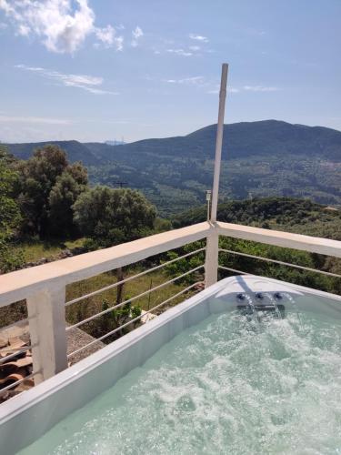 a hot tub with a view of the mountains at STATHIS GUESTHOUSE in Lefkada Town