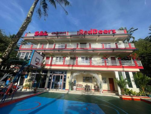 a hotel with a pool in front of it at RedDoorz at S & L Apartelle Daraga Albay in Legazpi