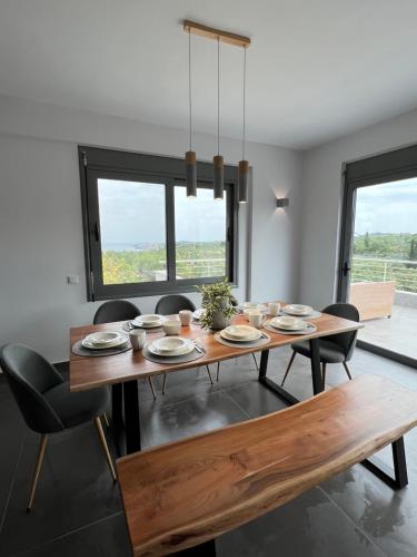 a dining room with a wooden table and chairs at Koroni Luxury Maisonette in Koroni