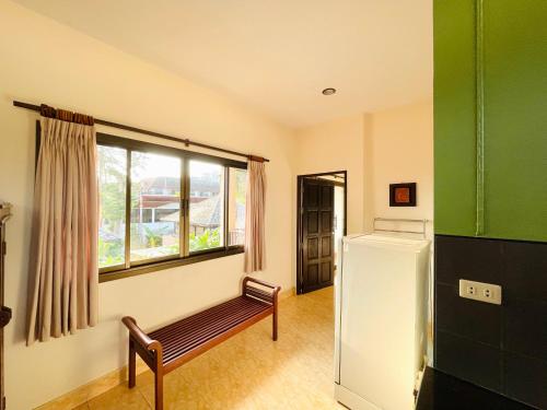 a room with a bench and a window and a refrigerator at Meewaya Hotel in Chaweng