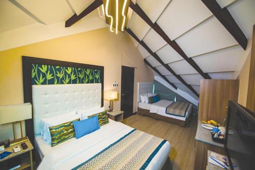 a bedroom with a bed and a tv in it at Acuatico Beach Resort & Hotel Inc. in San Juan