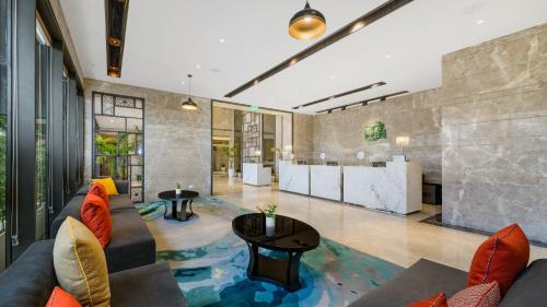 a living room with a couch and a table at Holiday Inn Gurugram Sector 90 by IHG in Gurgaon