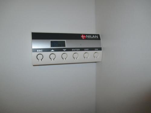 a microwave oven sitting on top of a wall at White House Hotel Apartments in Brande