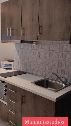 a kitchen with a sink and a counter top at Mamanis Studios in Loutra Edipsou