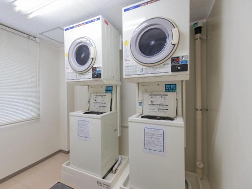 a laundry room with two washing machines on display at JR Kyushu Hotel Nagasaki in Nagasaki